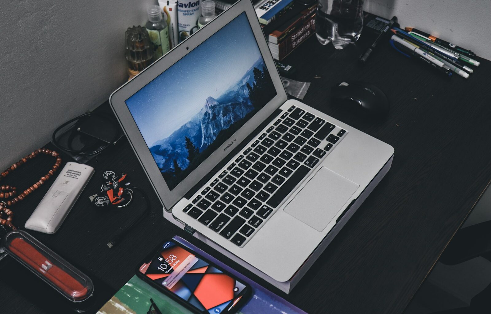 a laptop computer sitting on top of a wooden desk