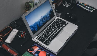 a laptop computer sitting on top of a wooden desk